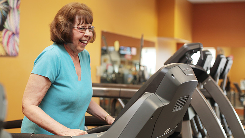 Indoor photo of a senior woman on treadmill